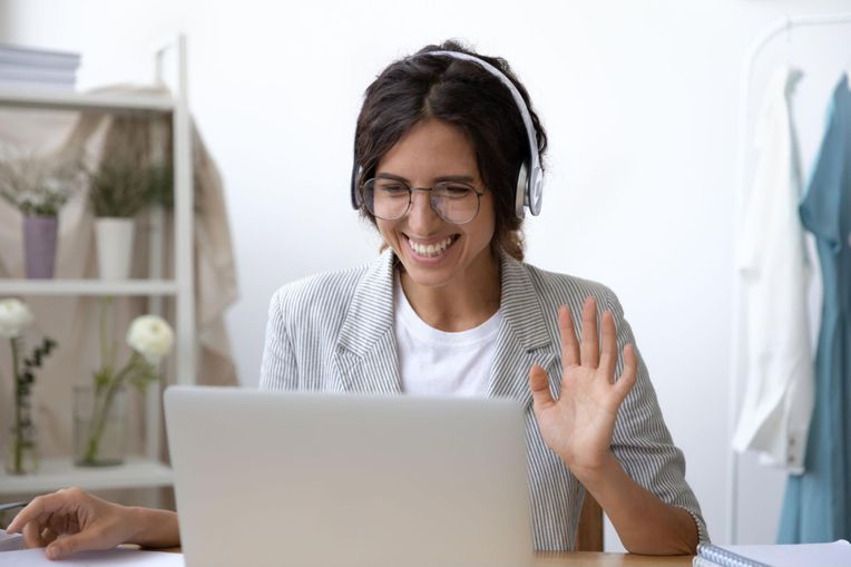 Employee waving while in online call